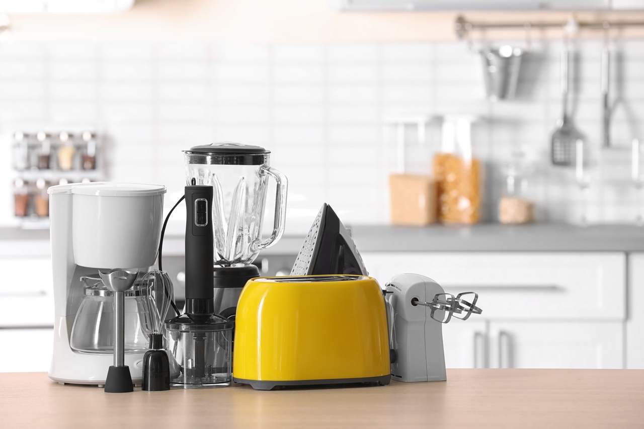 Household,And,Kitchen,Appliances,On,Table,Against,Blurred,Background